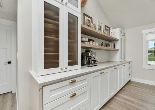 a-kitchen-with-white-cabinets-and-wood-floors.jpg a kitchen with white cabinets and wood floors