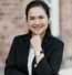 woman in black blazer smiling
